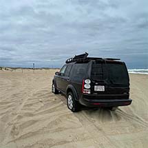 Photo of the Black Ghost at Cape Point North Carolina with the Hatteras Lighthouse in the background.